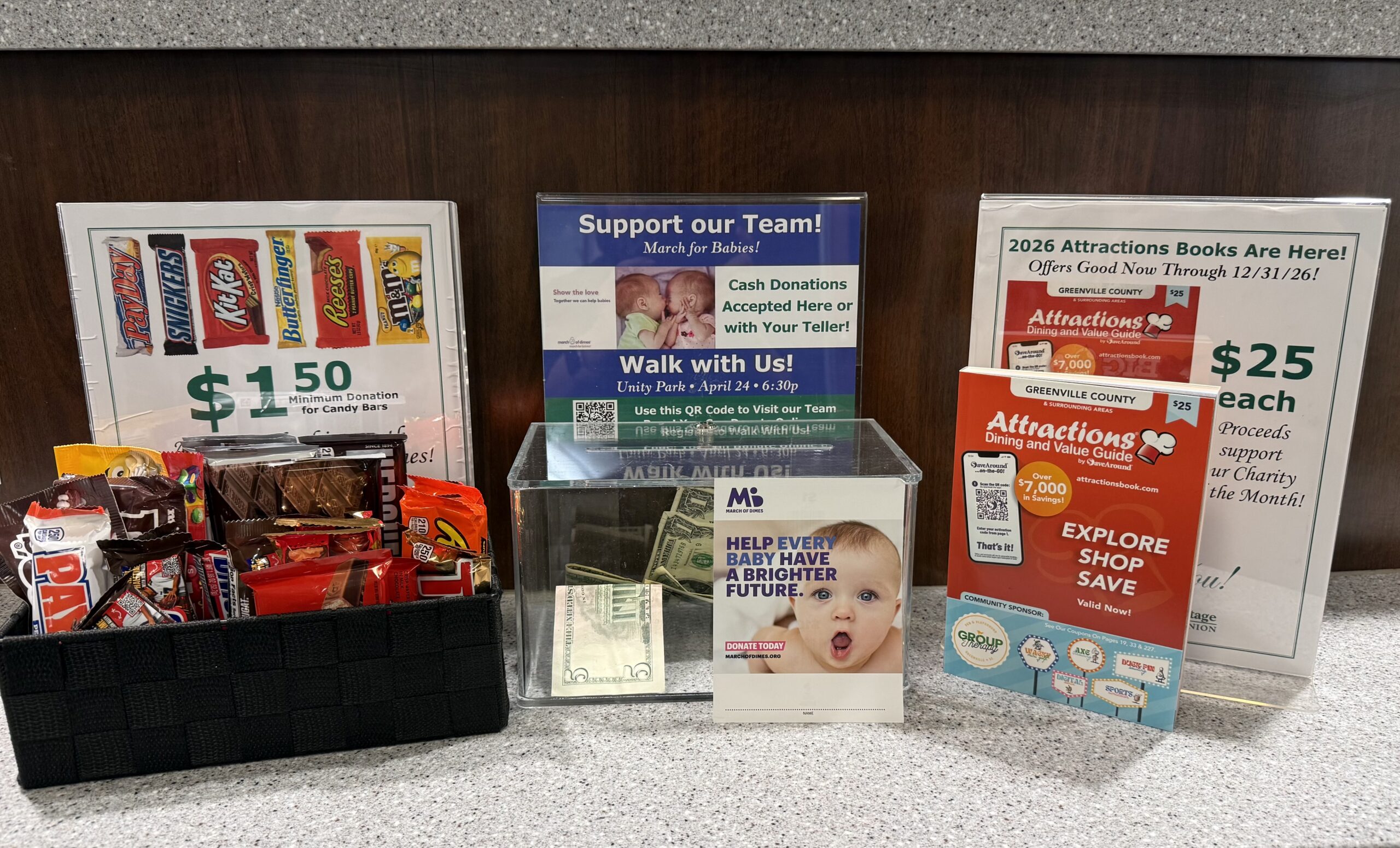 Candy, money, and Attractions Books displayed in Greenville Heritage Federal Credit Union Branch for month of March