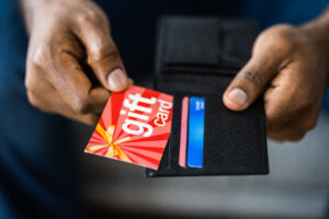 African Hand Holding Gift Card Shopping Voucher