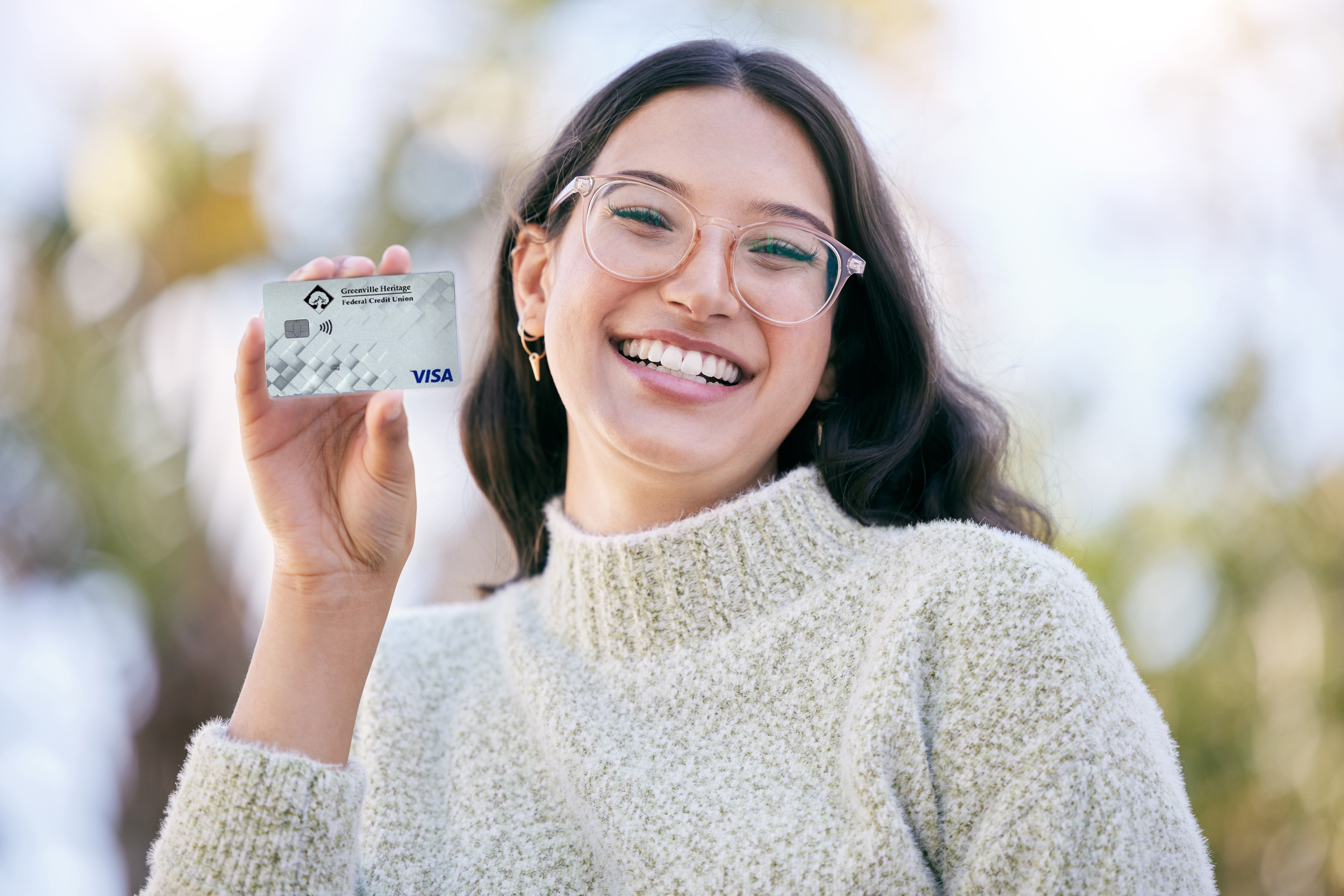 I,Made,The,Smart,Choice.,A,Happy,Young,Woman,Holding Girl holding Greenville Heritage Federal Credit Union credit card.