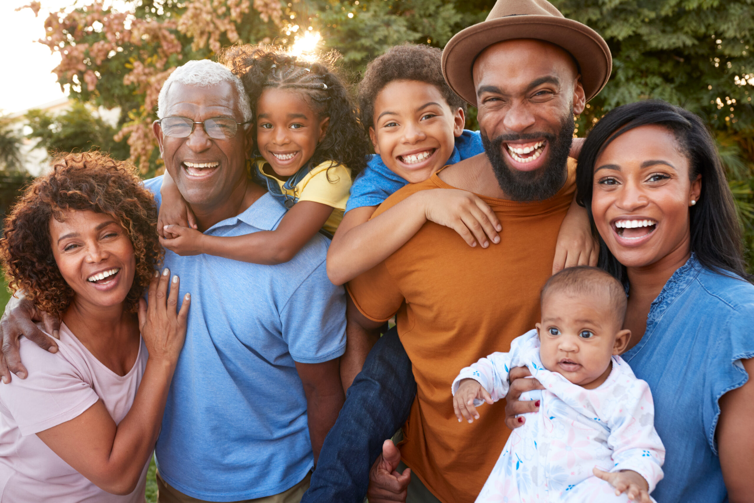 Portrait,Of,Multi-generation,African,American,Family,Relaxing,In,Garden,At